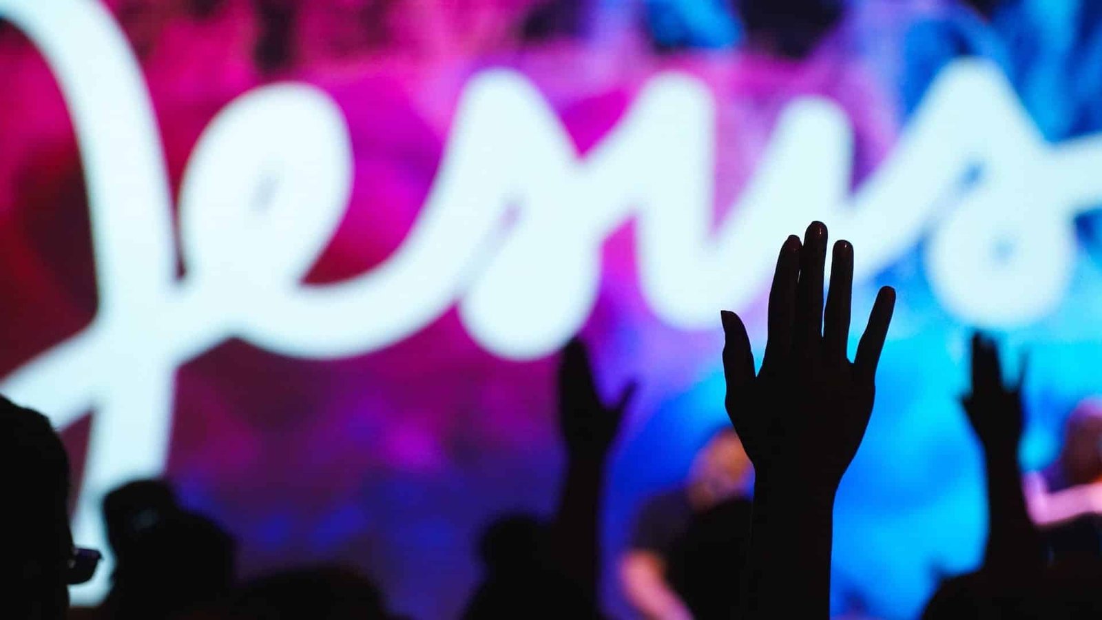 Man with hands raised in worship
